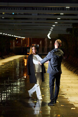 A beautiful young couple. A girl in white clothes and a man in black clothes at night in the park. - 788046509