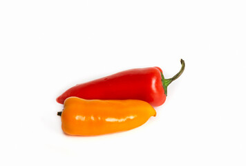 Two different colored small sweet peppers and chili peppers on a white isolated background