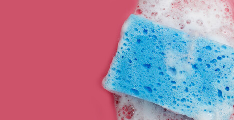 Cleaning sponge in foam of dishwashing liquid. Washing dishes concept