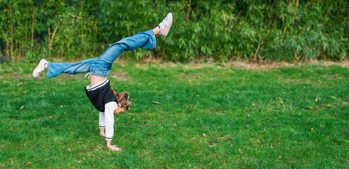 Gymnastics while walking in nature. A 10-12 year old girl spontaneously tries to do gymnastics...