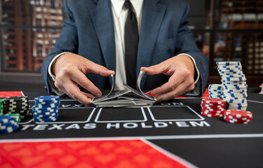 close up man hand with poker card at casino table