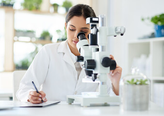 Scientist, microscope and writing in lab with research for sample analysis, medical experiment and...