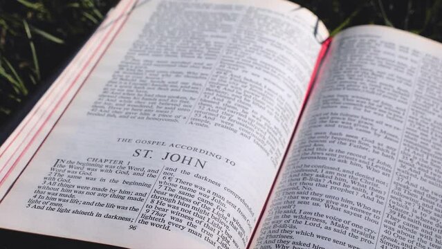 Bible Book on Field of Grass on a Sunny Day, Gospel of St John