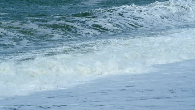 Beautiful Seascape Waves Rolling To Beach. Strong Winds Push Around Sand And Violent Waves At Beach. Real time.