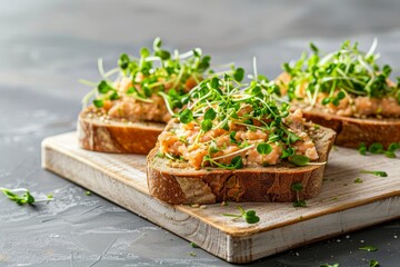 Toast with salmon pate green sprouts on yeast free bread wood cutting board Grey background copy space