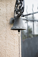 A cast bell at the front door for notification is an ancient element of architecture and decor