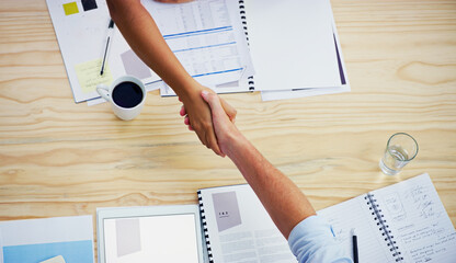 Partners, handshake and agree in meeting at desk, deal and thank you for merger at finance firm....