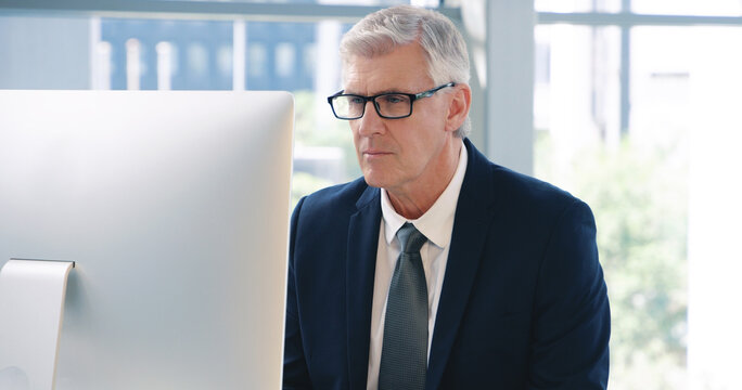Fototapeta Mature man, corporate and pc on desktop for executive job, internet connection and reading email. Expertise, technology and face of senior ceo in workplace with business, checking schedule and online
