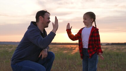 Daughter father special handshake greeting clapping hands gesture expressing strong close family...