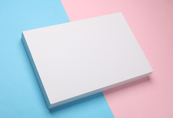 White cardboard box on blue pink pastel background