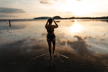summer travel,Woman walking on the beach in the evening