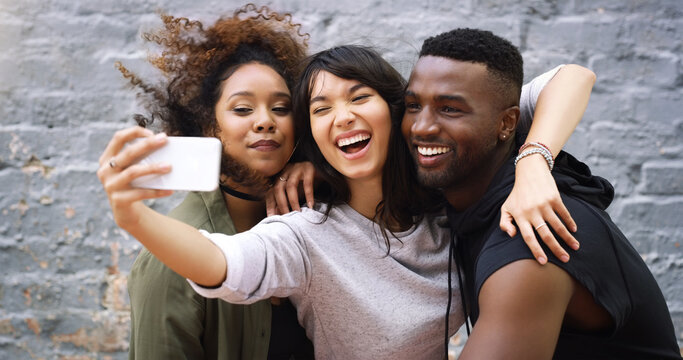 Diversity, selfie and social media with friends on brick wall background in city for profile picture. App, happy or smile with man and woman group outdoor together for bonding, fun or photography