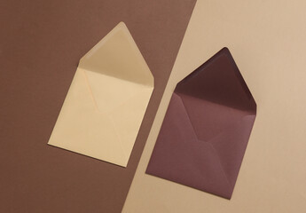 Envelopes on beige brown background. Invitations, corporate identification. Creative layout