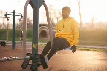 Man working out on leg press machine in an outdoor gym
