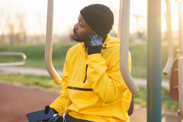 Man listening to the music while taking an outdoor workout break