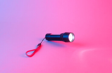 Pocket flashlight in blue pink neon gradient light