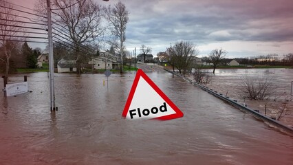 Submerged street and yards with a Flood warning sign, turbulent water, and stormy sky. Graphic...