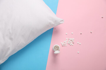 Pillow and pills on a blue-pink background. Treatment of insomnia
