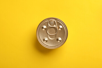 Can with canned pet food on yellow background. Top view. Flat lay