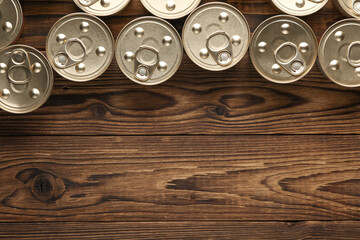 Many Cans with canned food on wooden background. Top view. - obrazy, fototapety, plakaty