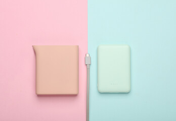 Two Plastic power banks on blue pink pastel background