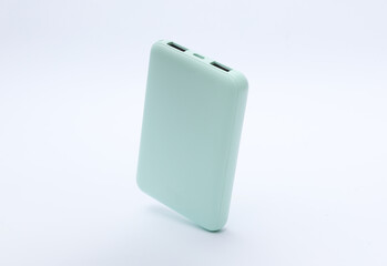 Mint green plastic power bank floating on white background