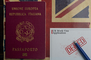 UK work visa concept: italian passport next to a denied work visa