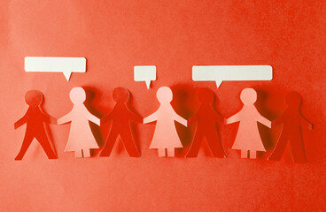 Paper cut chain of people holding hands and speech bubbles on red background. Unity concept