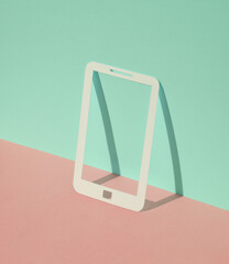 Paper-cut smartphone on blue-pink pastel background