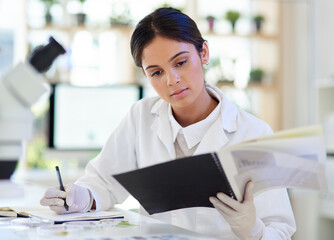 Science, researcher and woman writing in lab, review experiment and feedback for breakthrough....