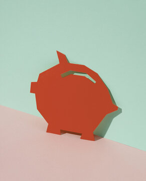 Red Paper-cut Piggy bank on blue-pink pastel background. Creative layout