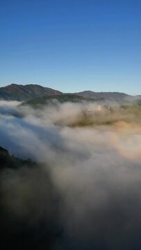 Aerial view of misty mountains and Gujo Hachiman Castle at sunrise, Gujo, Gifu, Japan.