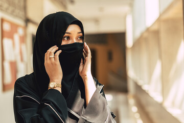 Muslim niqab woman Arab saudi girl closeup close face with black chador.