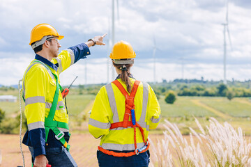 Engineer team working group survey at wind turbine clean power generator service maintenance wind...