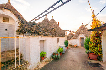 Trulli of Alberobello, Puglia, Italy. town of Alberobello with trulli houses among green plants and...