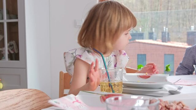 Cute Young Caucasian Preschooler Girl Sitting at Table Set For Traditional Polish Festive Family Easter Sunday Breakfast