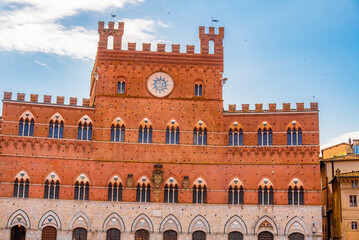 Naklejka premium Siena, medieval town in Tuscany, with view of the Dome & Bell Tower of Siena Cathedral, Mangia Tower and Basilica of San Domenico, Italy