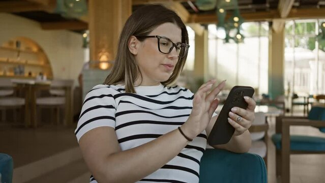 A woman using a smartphone in a modern restaurant, capturing the intersection of technology and dining.