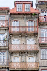 Typical facade of the buildings of the beautiful city of Porto, Portugal. With its windows, balconies and hanging clothes. Next to the Douro river.