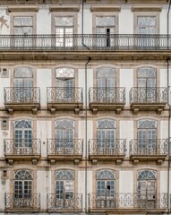 Typical facade of the buildings of the beautiful city of Porto, Portugal. With its windows, balconies and hanging clothes. Next to the Douro river.