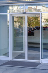 Fototapeta na wymiar Closed Pair of Automatic Doors With Sensor Detection Commercial Building Entrance
