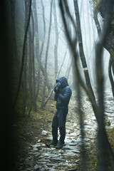 Creepy portrait with gas mask in a foggy forest