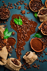 Aromatic coffee beans. Set of coffee beans in the shape of a world map of South America. Top view. On a dark background.