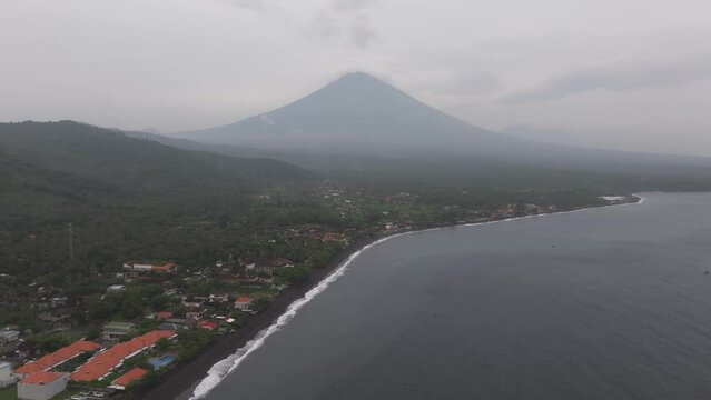 Aerial view of Agung volcano, beach, and boats at sunrise, Amed, Bali, Indonesia.