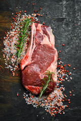 Raw steak. Beef steak with seasonings on a wooden board, close-up. - 788119525