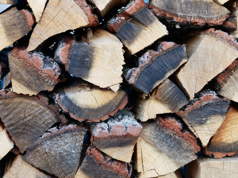Chopped firewood stacked in a woodpile close-up