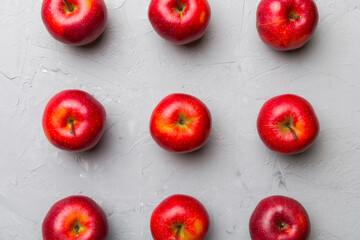 Many red apples on colored background, top view. Autumn pattern with fresh apple above view