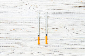 Top view of insulin syringe prepared for injection at wooden background. Diabetes concept with copy...