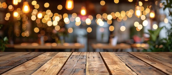 Wooden table in front of a blurred background featuring restaurant lights. - obrazy, fototapety, plakaty