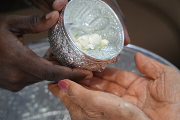 Pour water on the hands of revered elders and ask for blessing.